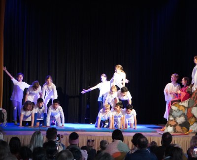 Children do acrobatics on stage